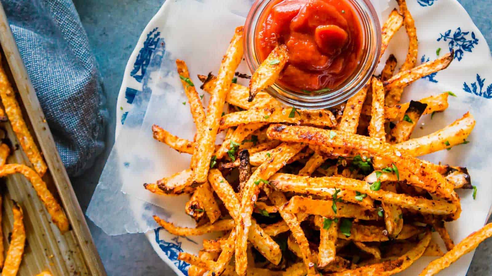 Jicama fries on a plate with ketchup.