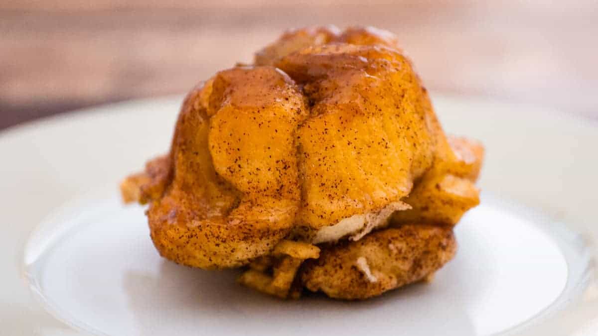 Cinnamon sugar monkey bread muffin on a white plate.