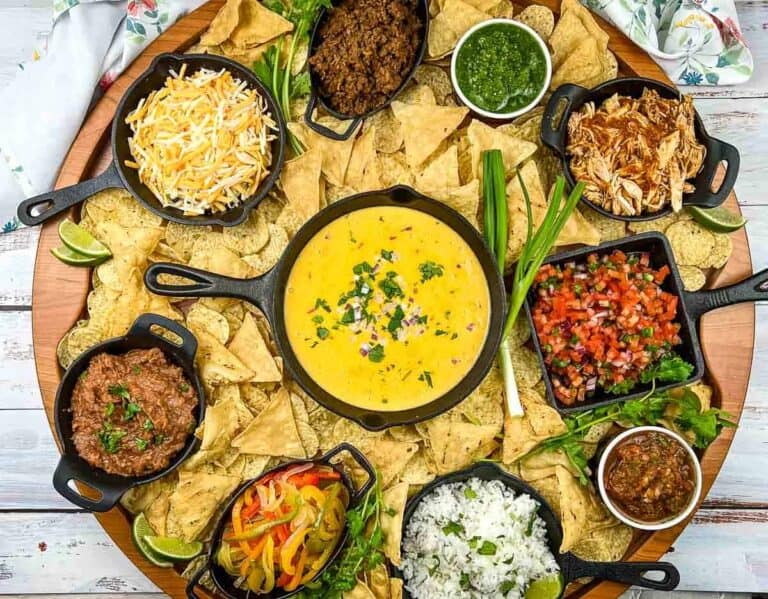 A platter of nachos with different toppings.