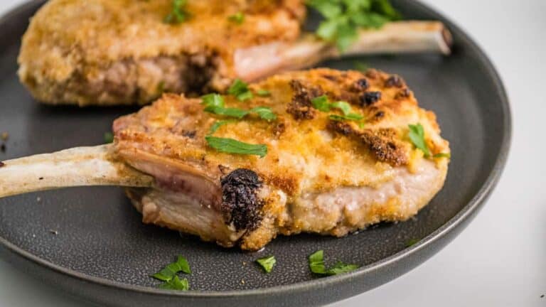 Two fried pork chops on a plate.