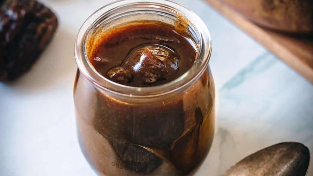 A jar of brown sugar syrup with a spoon next to it, perfect for 39 quick recipes.