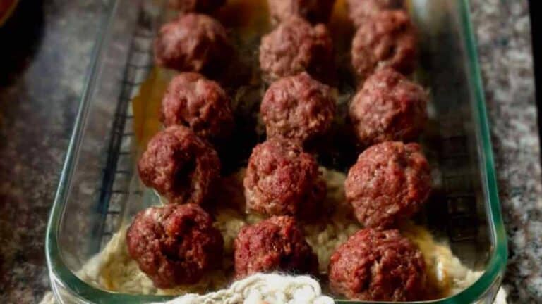 Meatballs in a glass baking dish on a table.