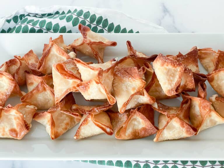 A plate of fried wontons on a white plate.