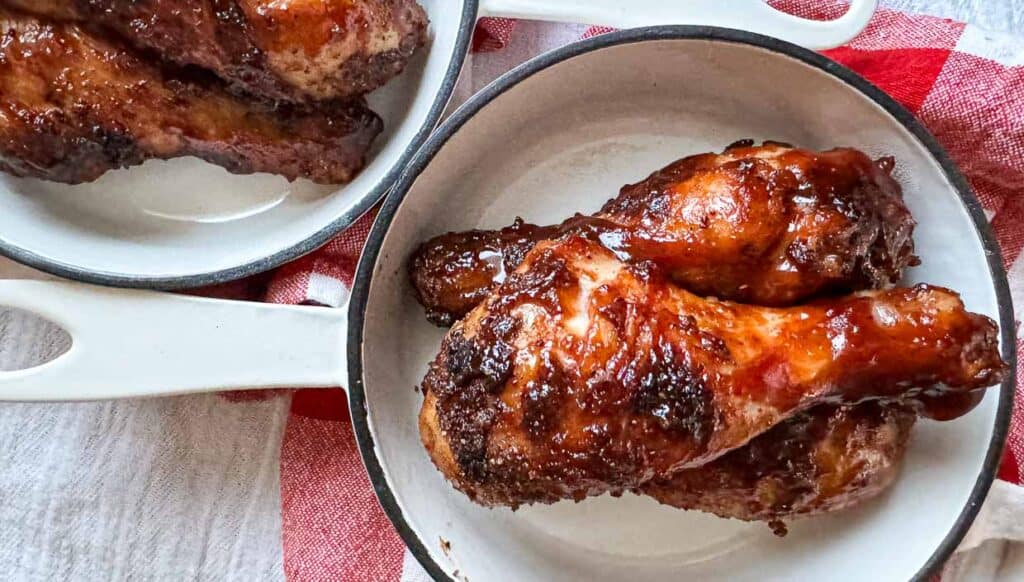 A chicken drumsticks in a pan.