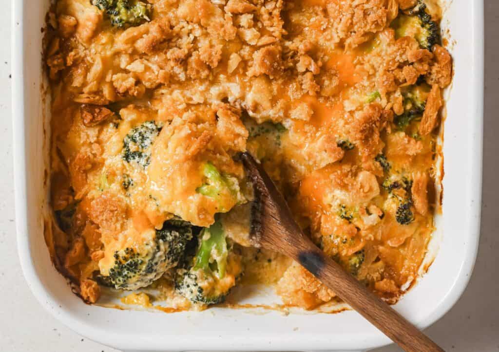 A casserole dish with broccoli and cheese in it.