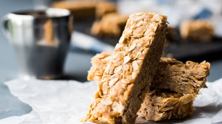 A stack of granola bars on a piece of parchment.