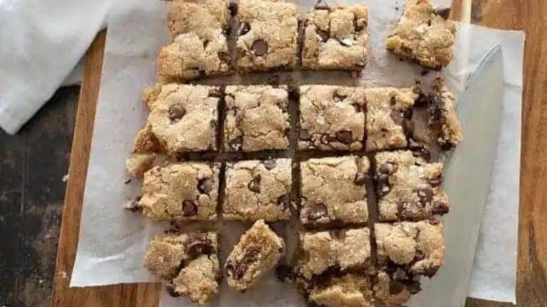 Chocolate chip cookie bars on a cutting board.