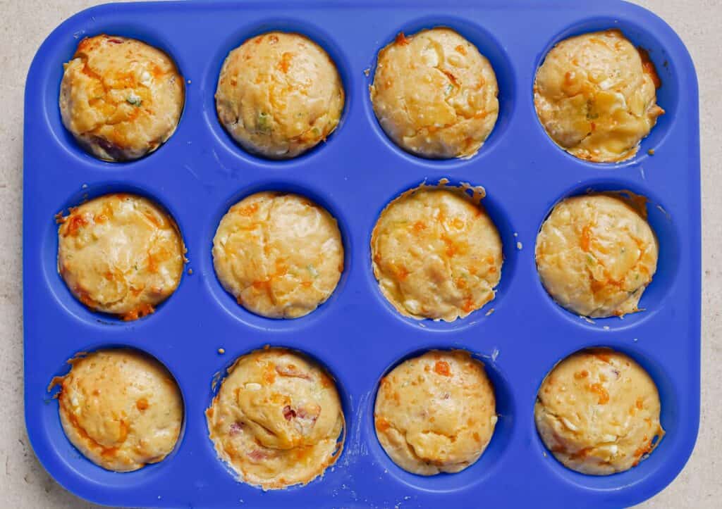 A blue muffin pan filled with breakfast muffins.