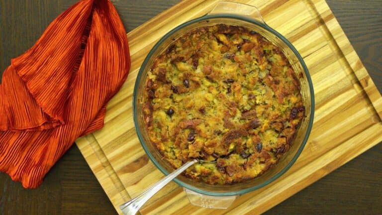 A dish of stuffing on a cutting board.