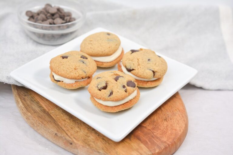 A plate of cookies on a wooden board.