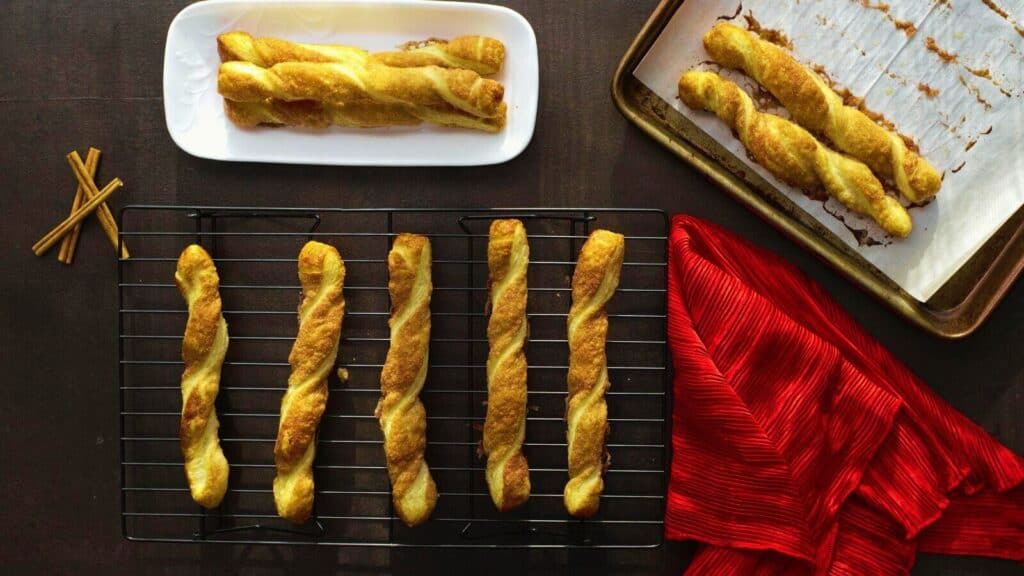 A tray of cinnamon twists on a baking sheet.