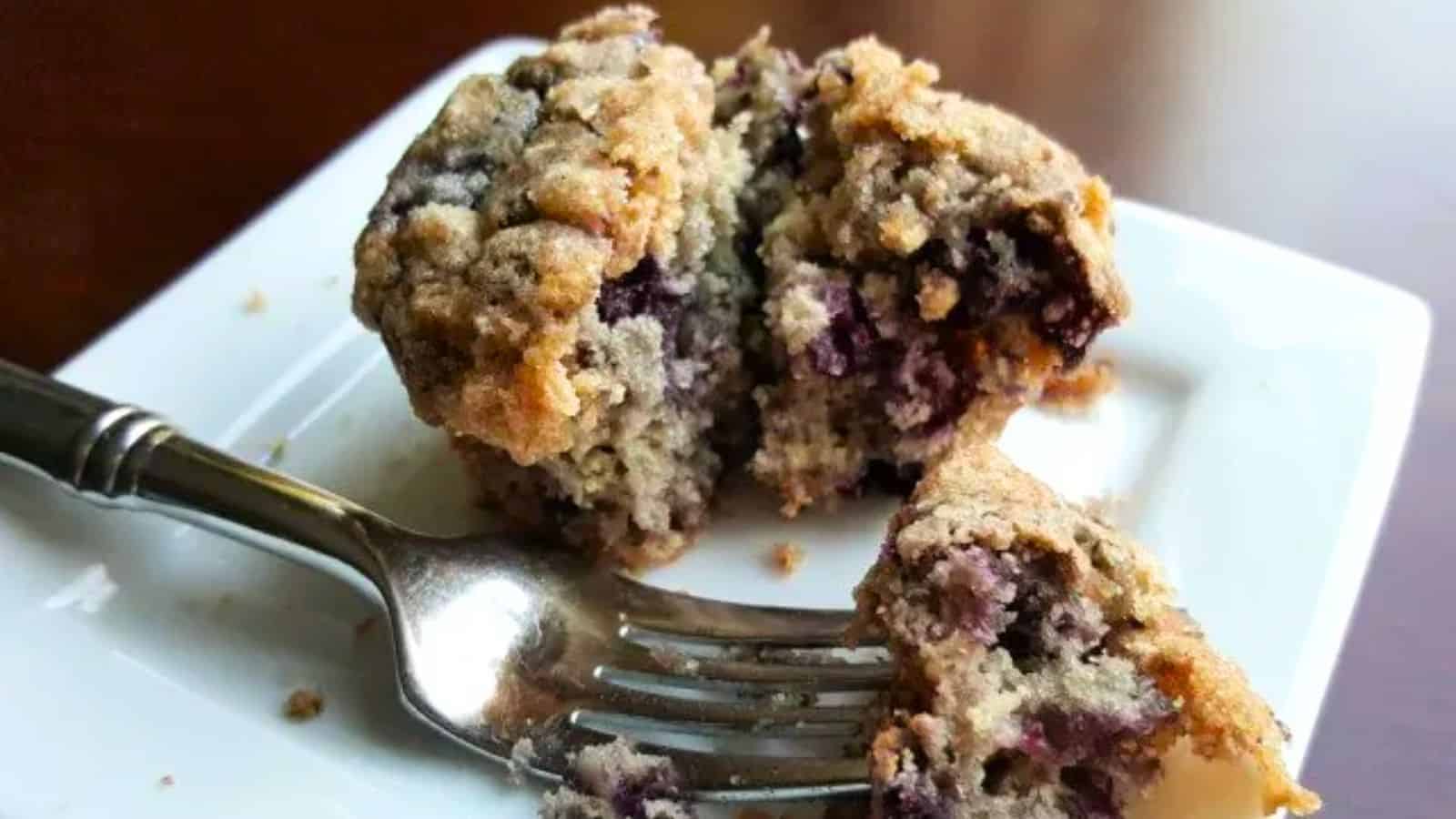 Image shows an Individual Blueberry Coffeecake on a plate with a fork holding a bite.