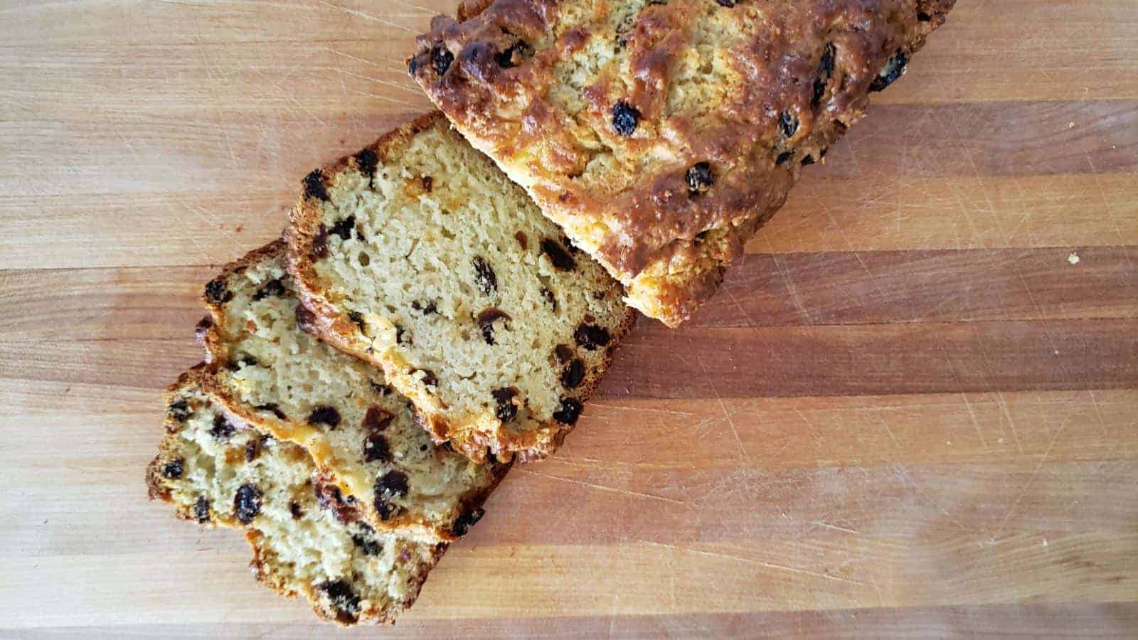 Overheard of a loaf of irish soda bread with slices cut.