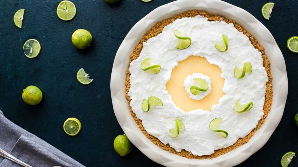 A key lime pie with whipped cream and lime garnish.