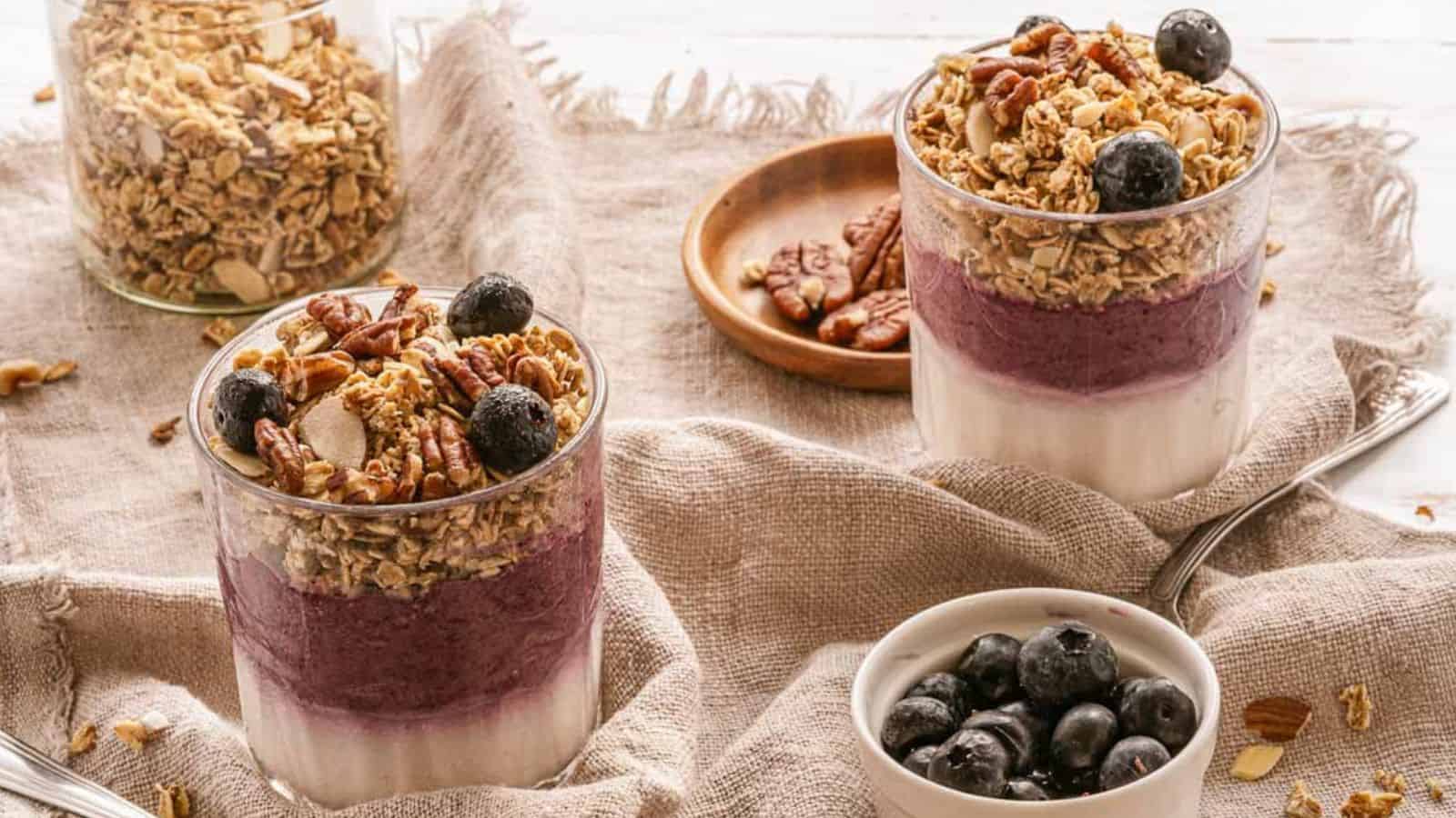 A bowl of granola with blueberries and pecans.