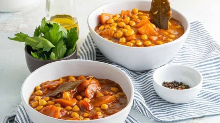 Two bowls of chickpea stew on a table.