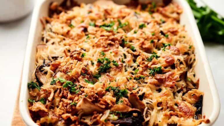 A casserole dish with bacon and mushrooms.
