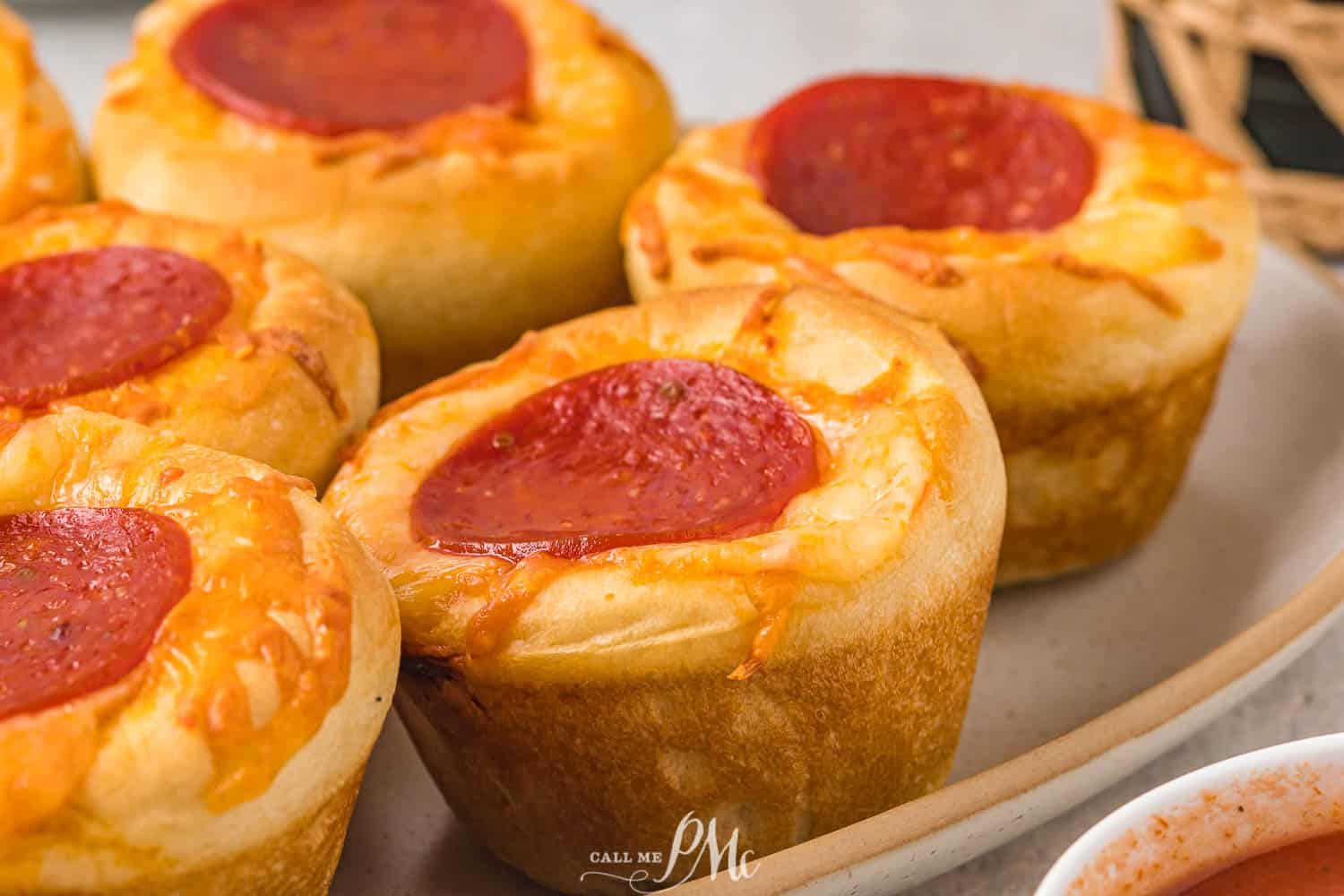 Pizza muffins on a plate.