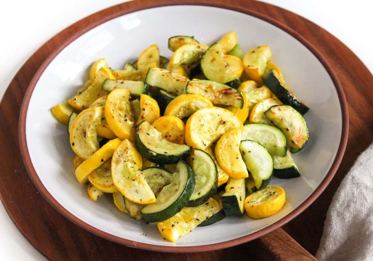 Oven roasted sliced zucchini and squash in a large serving bowl.