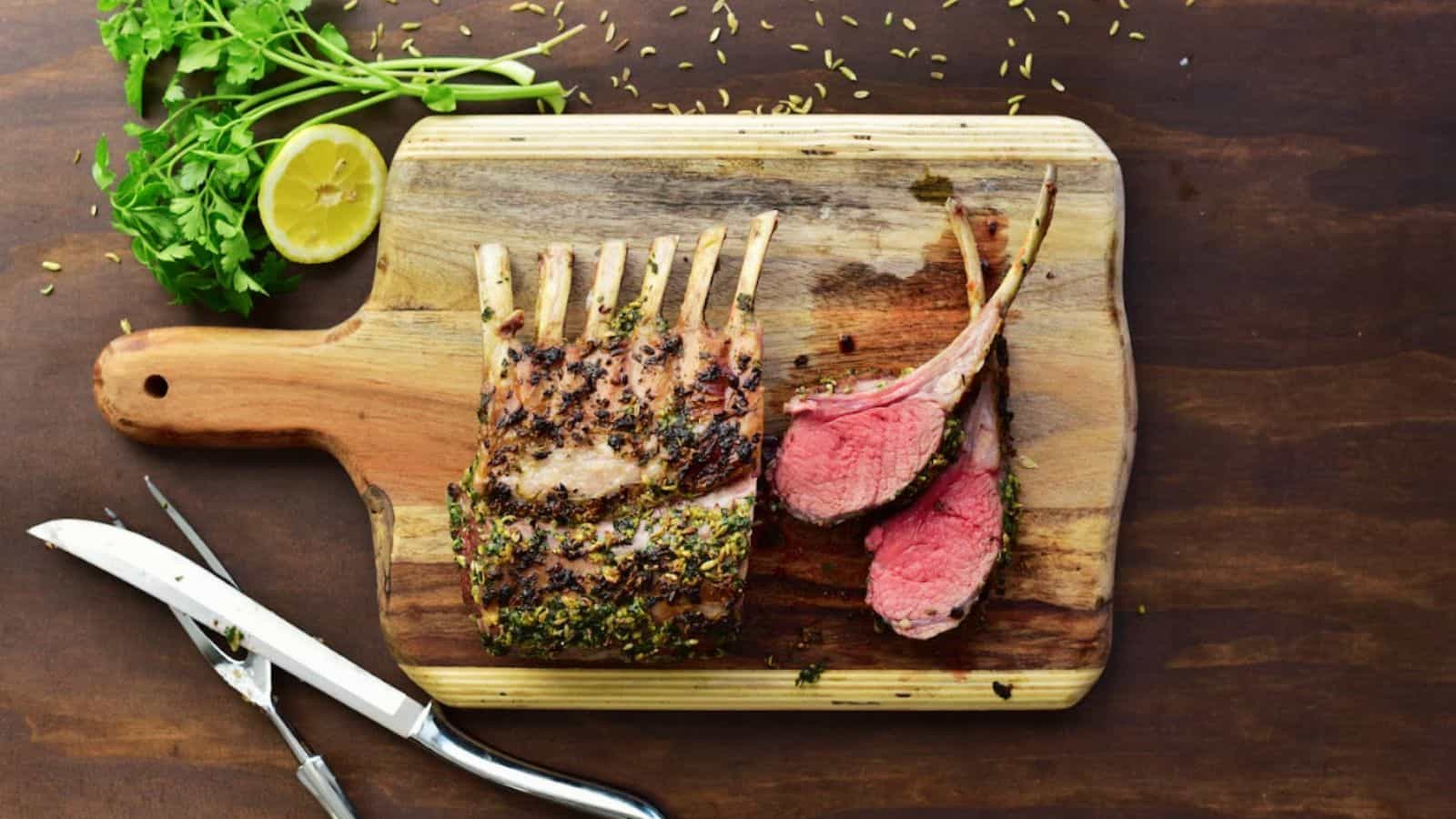 Roasted rack of lamb on a cutting board.
