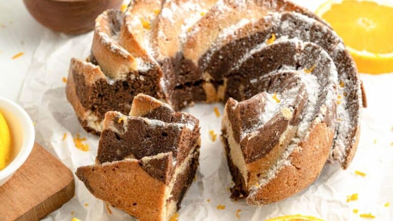 A chocolate bundt cake with orange slices on top.