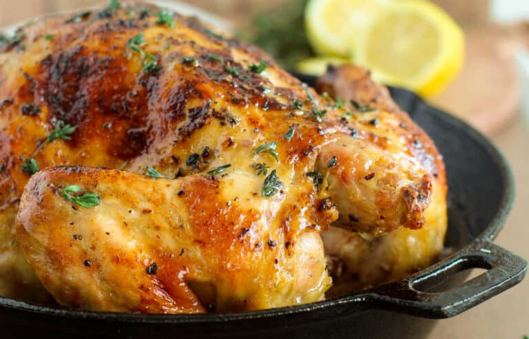 A roasted chicken in a cast iron skillet.