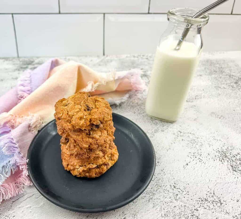 Scratch Made cookies on a plate next to a bottle of milk.