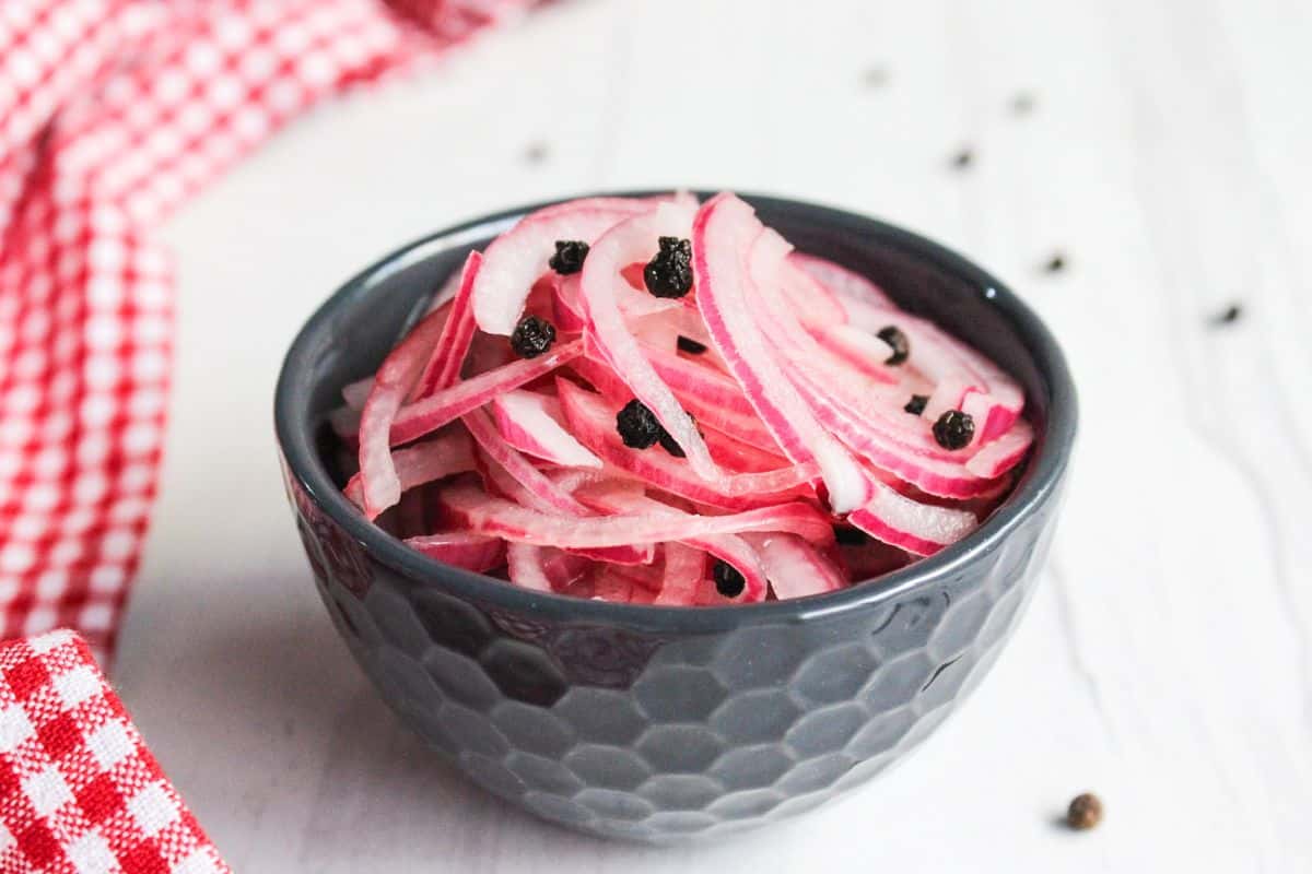 Onions in a bowl with black pepper.