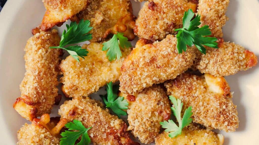 Fried chicken wings on a plate with parsley.