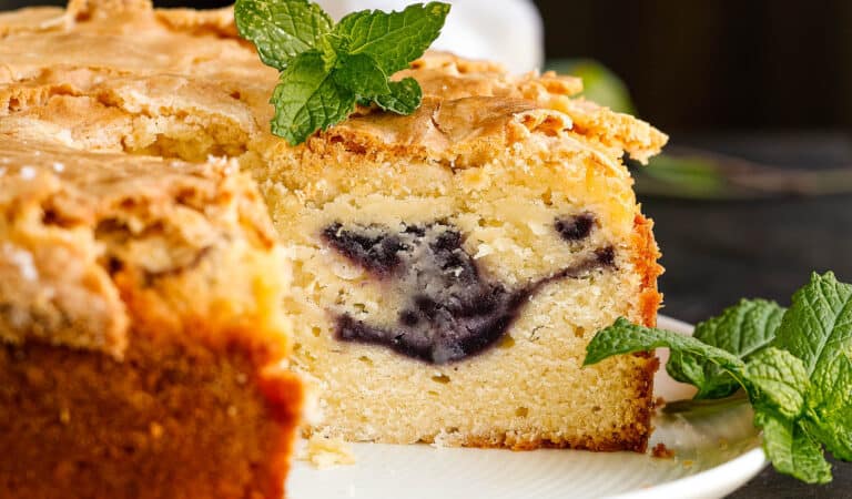 A slice of blueberry coffee cake on a plate.