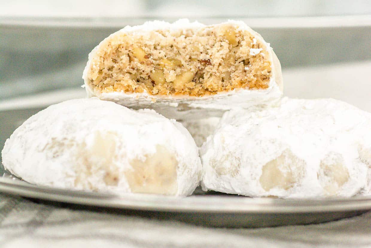 A plate of cookies with a bite taken out of them.
