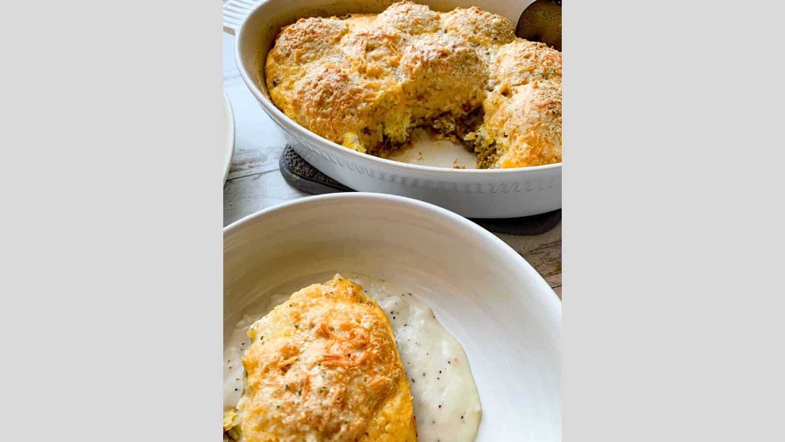 Sausage and gravy biscuit casserole in a baking dish and a serving bowl with the same and white gravy.