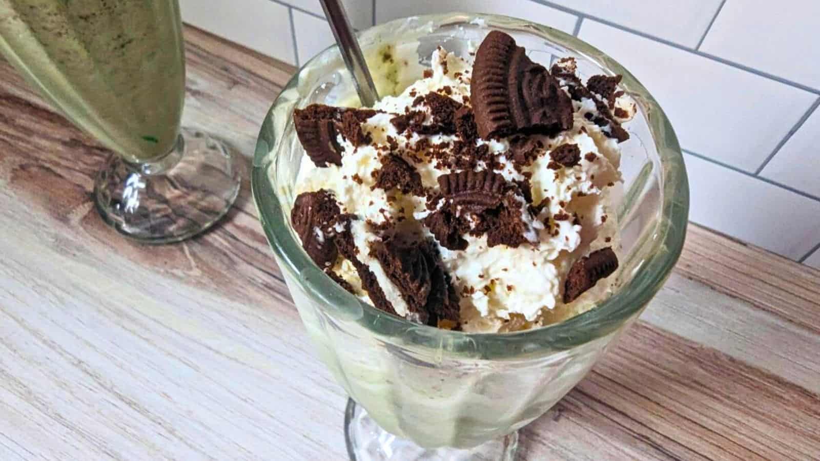 Image shows an overhead shot of a Copycat Oreo Shamrock McFlurry in a milkshake glass.