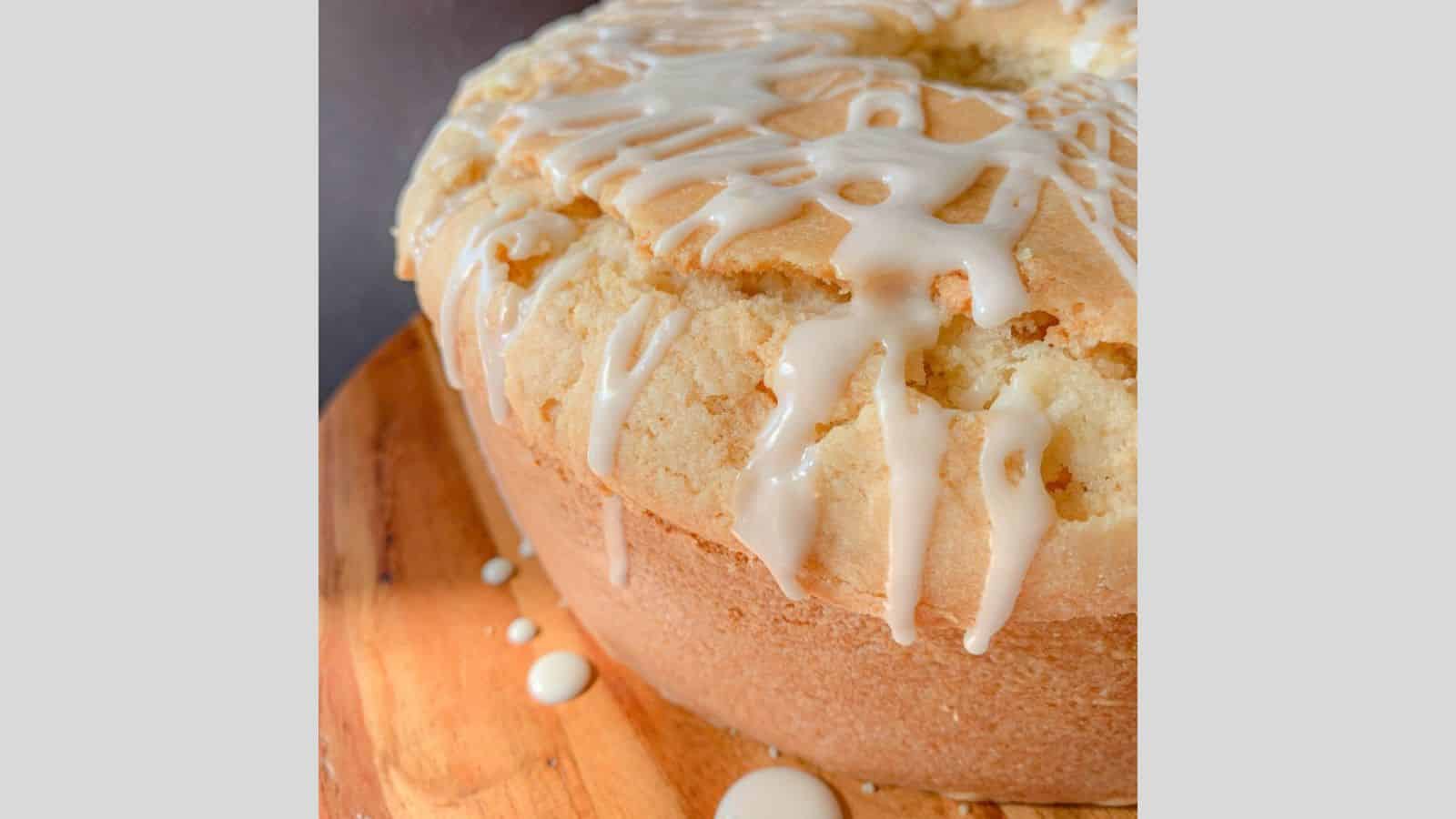 A large pound cake with sugar glaze dripping over the edges and down the sides.