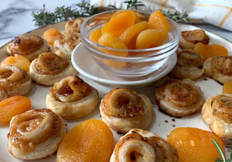 A plate with pears and apricots on it.