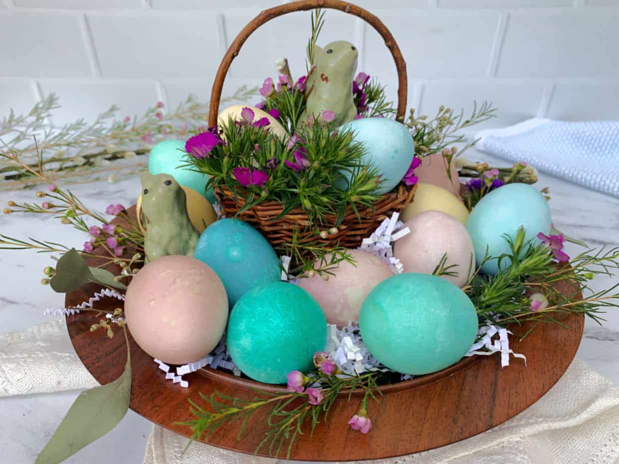 Colorful easter eggs in a box on a marble table.