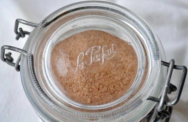 A glass jar with mocha mix in it.