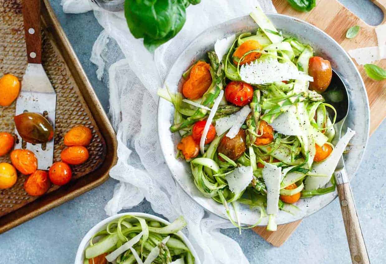 Lemony shaved Asparagus Tomato Salad in a white bowl.