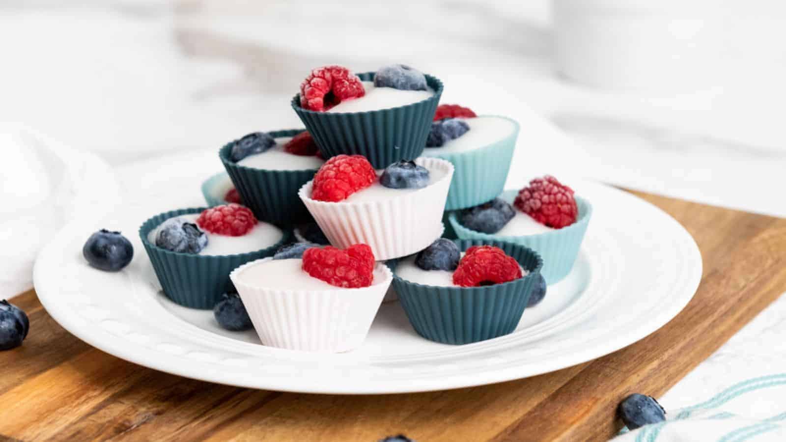 A pile of frozen yogurt cups on a plate.