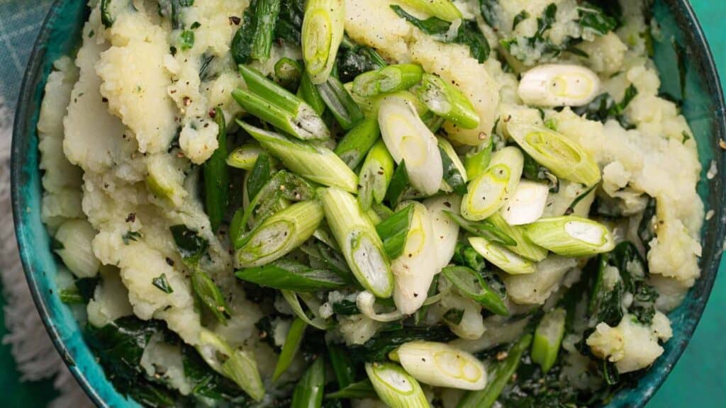 Mashed potatoes with asparagus in a blue bowl for St Patrick's day.