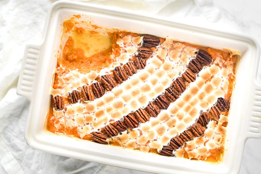 A sweet potato casserole with a scoop out of it.