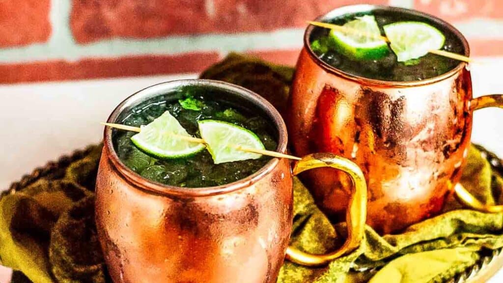 Two copper mugs filled with Moscow mule cocktails.
