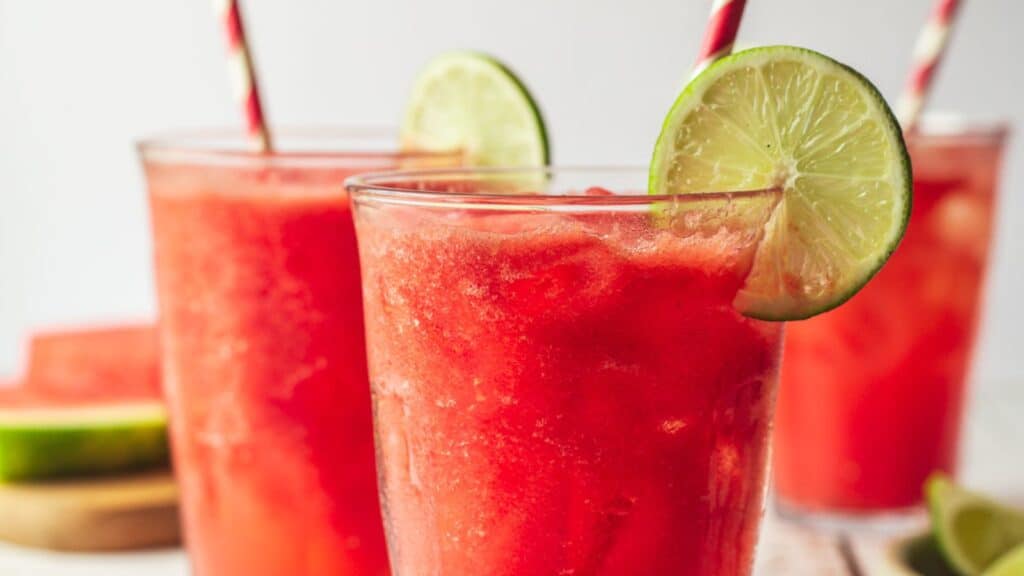 Refreshing watermelon smoothies with lime garnish, striped straws, and 13 cool drinks.