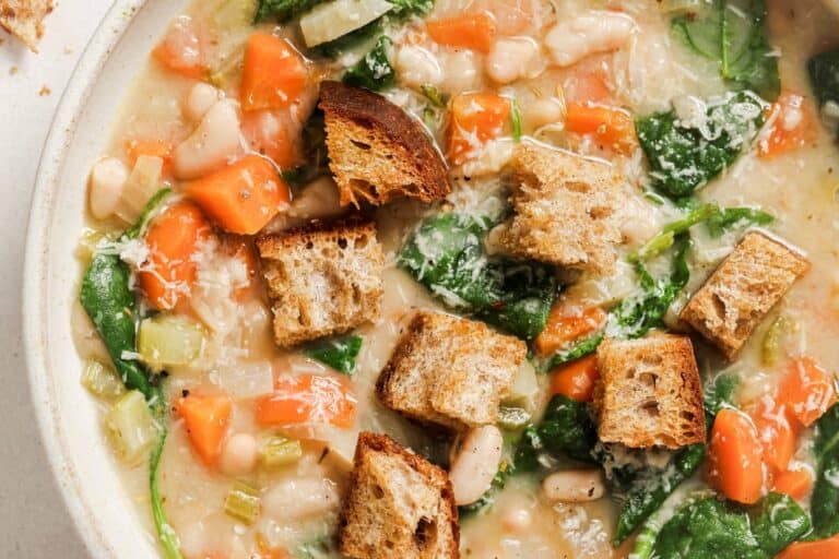 Hearty white bean soup with croutons and spinach.