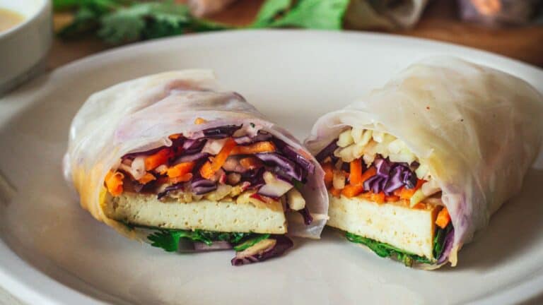 Fresh spring rolls with tofu and vegetables on a plate.