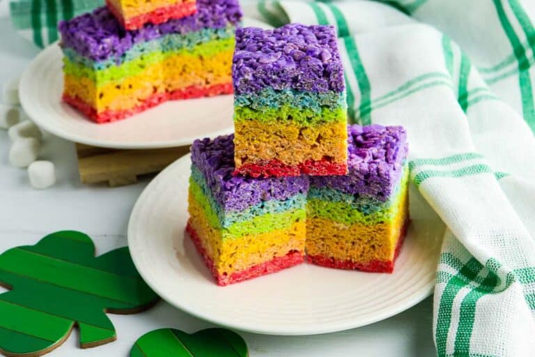 Rainbow rice krispie treats on a plate.