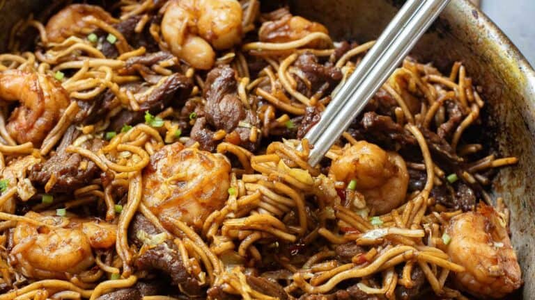 Stir-fried noodles with shrimp and beef in a pan.