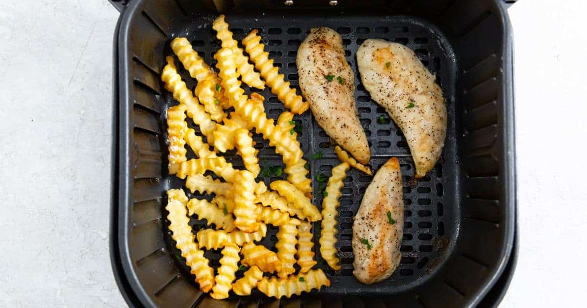 Easy Air Fryer Chicken Tenders and Fries on a white plate with parsley.