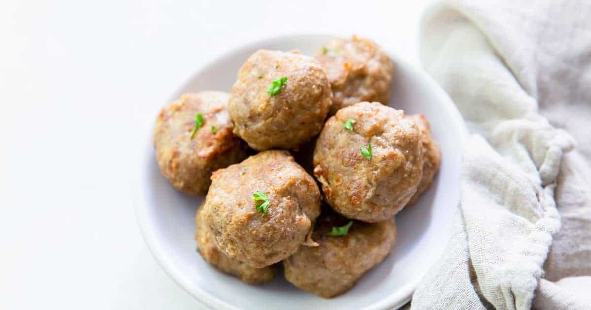 Air Fryer Turkey Meatballs in a white bowl with parsley.
