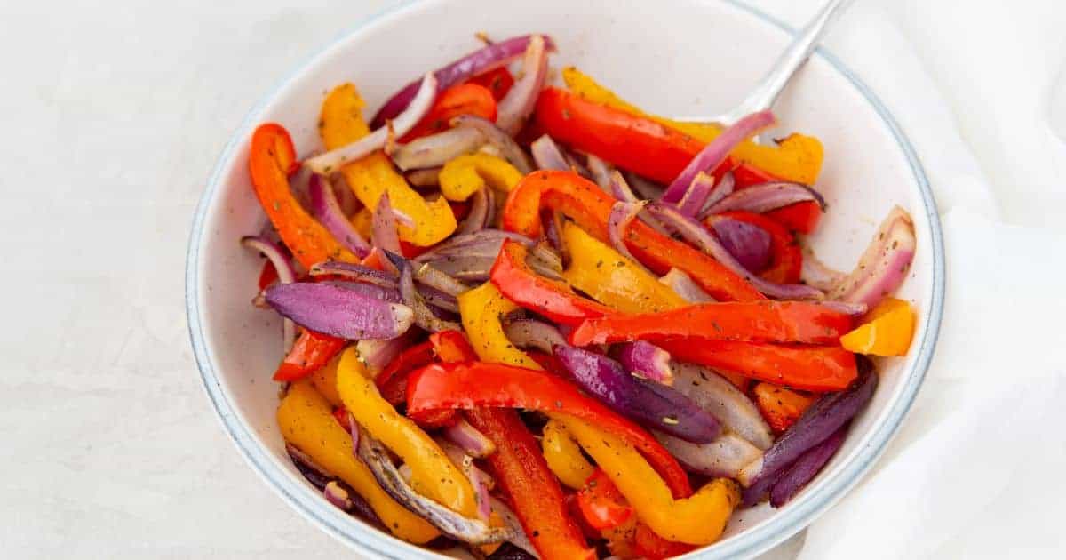 Air Fryer Peppers and Onions in an air fryer basket.